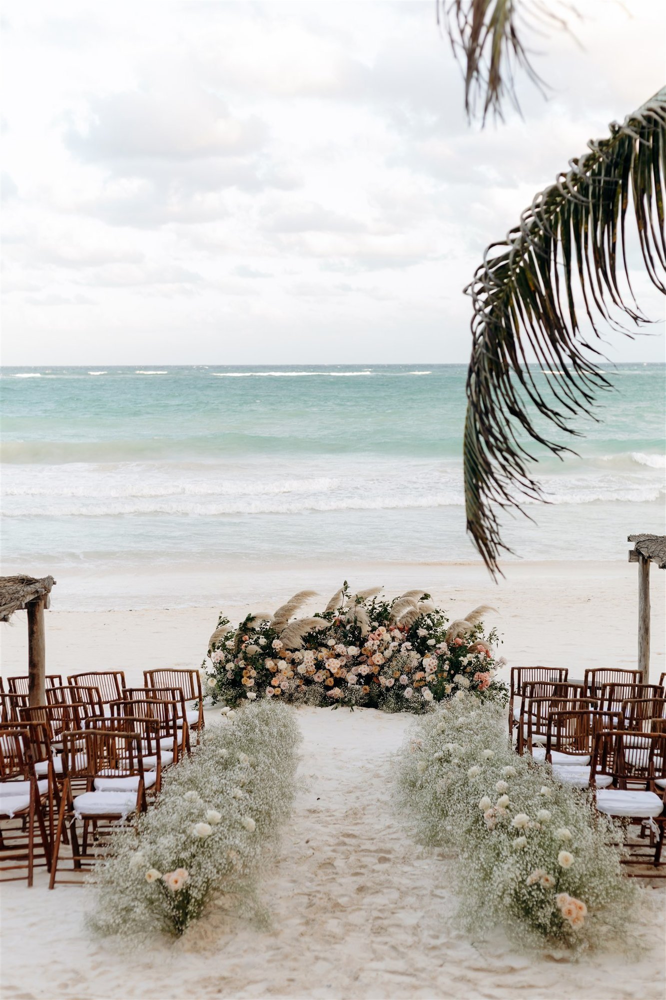 Floral ceremony aisle facing the Caribbean in Tulum