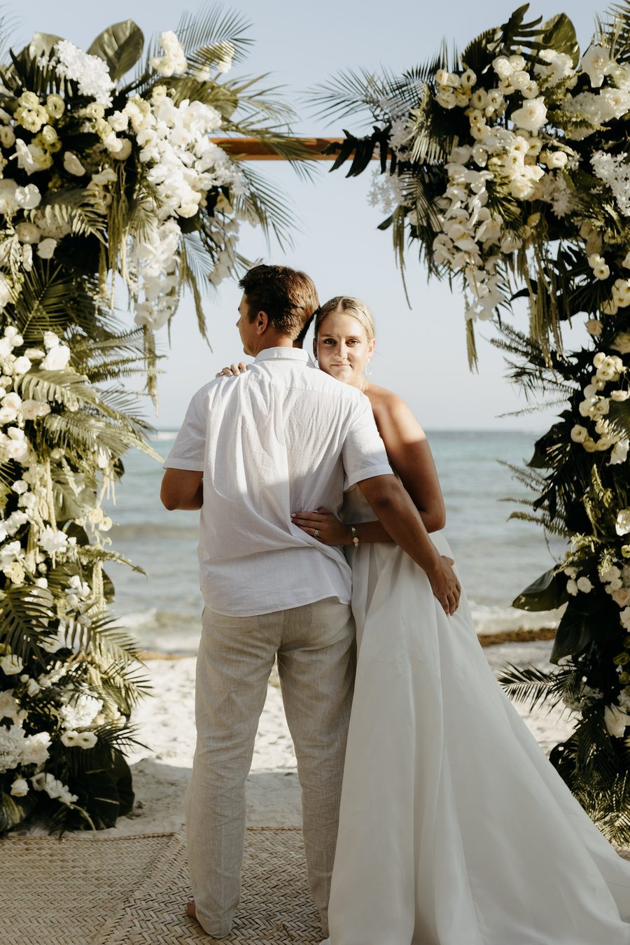 Beach wedding ceremony at sunset
