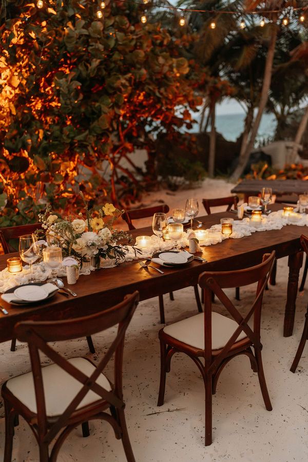 A long table set on the beach at Casa Carolina
