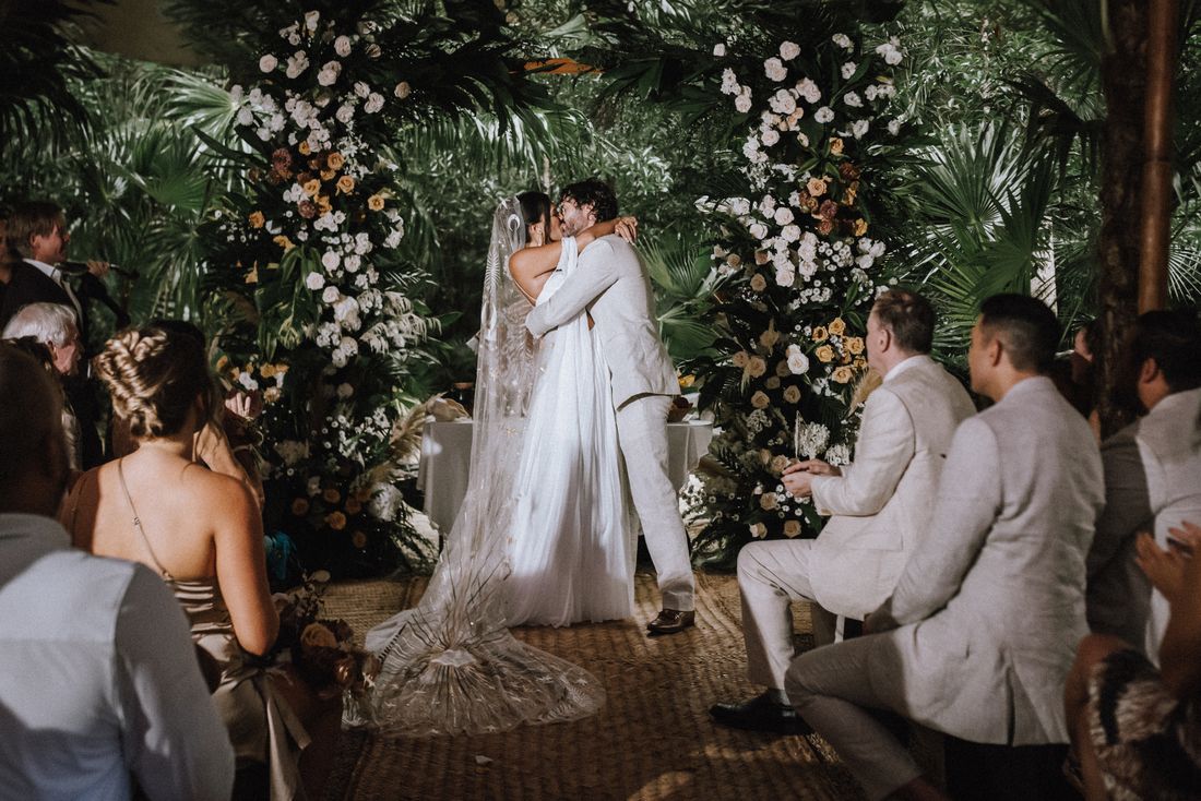 Ceremony under the floral arch · Tulum