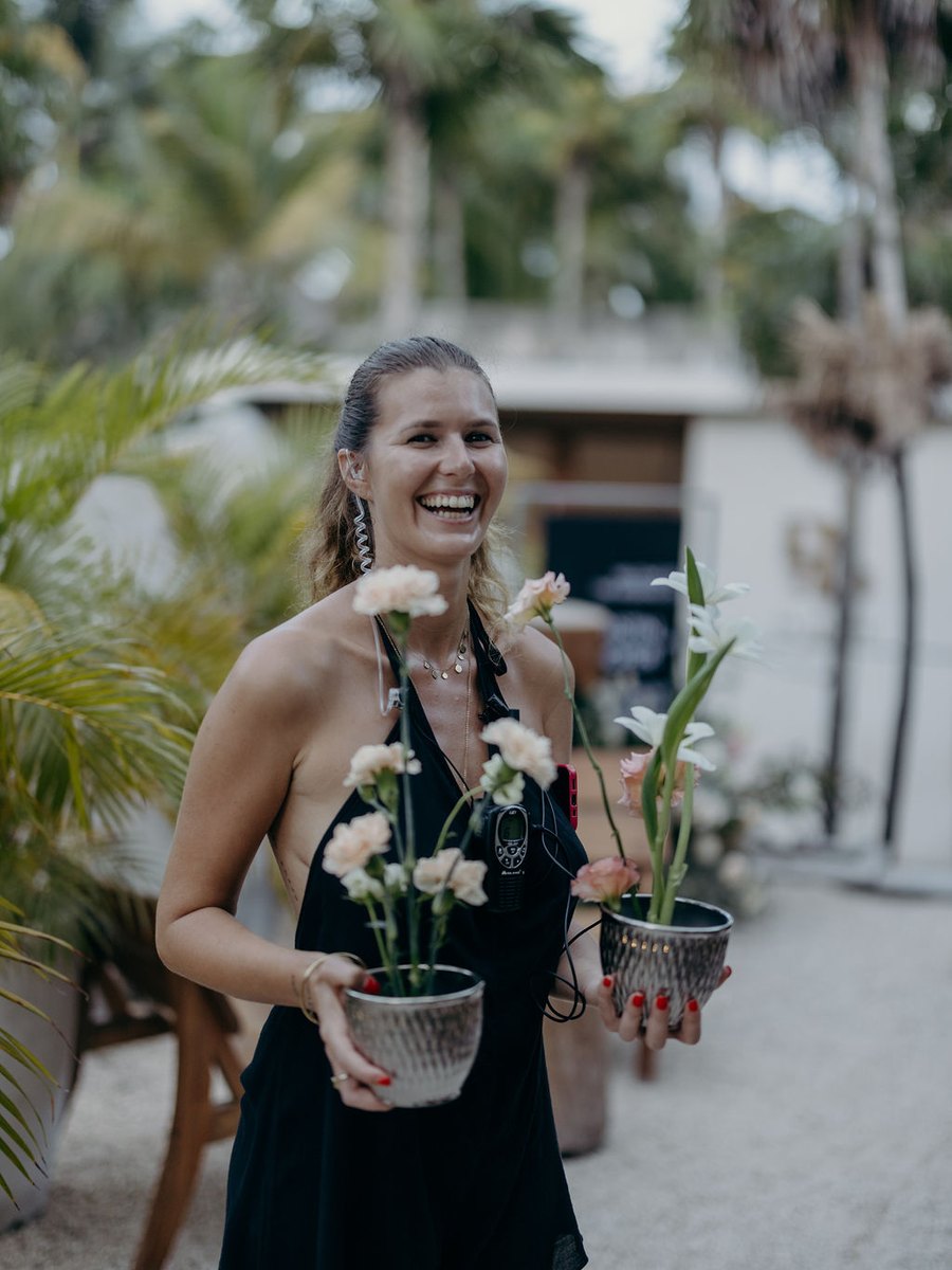 Juliette preparing florals for the celebration — Destination Weddings Tulum team