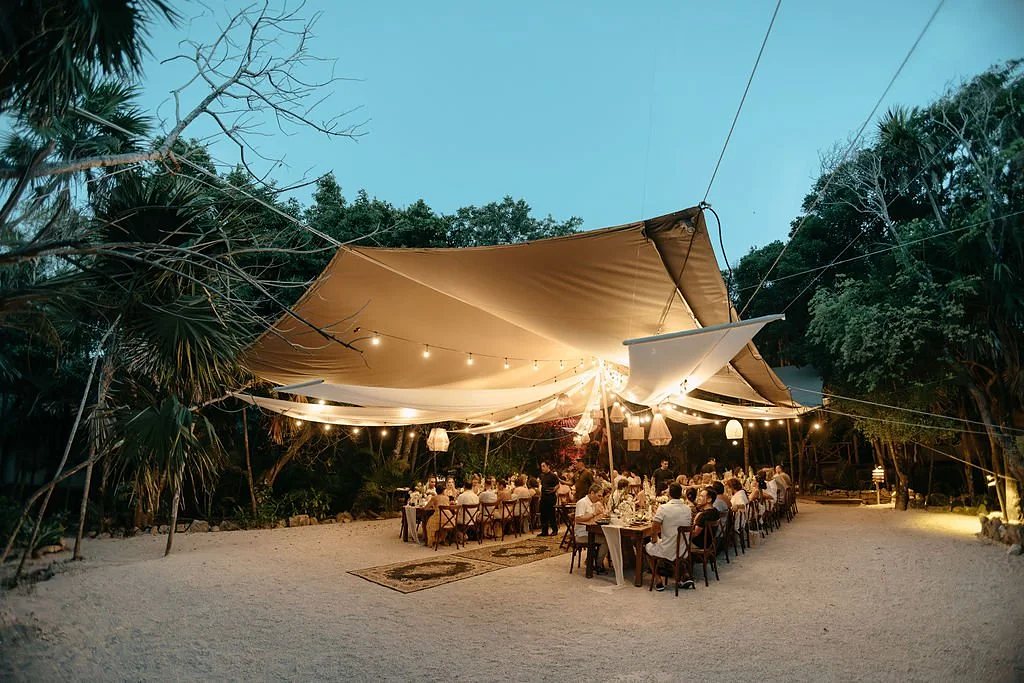 Candlelit dinner under a sailcloth tent in the Tulum jungle