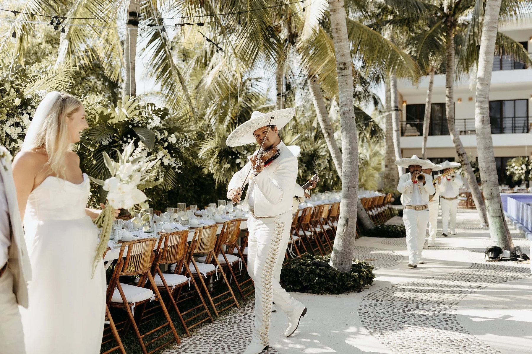 Long-table wedding dinner under the palms in Tulum