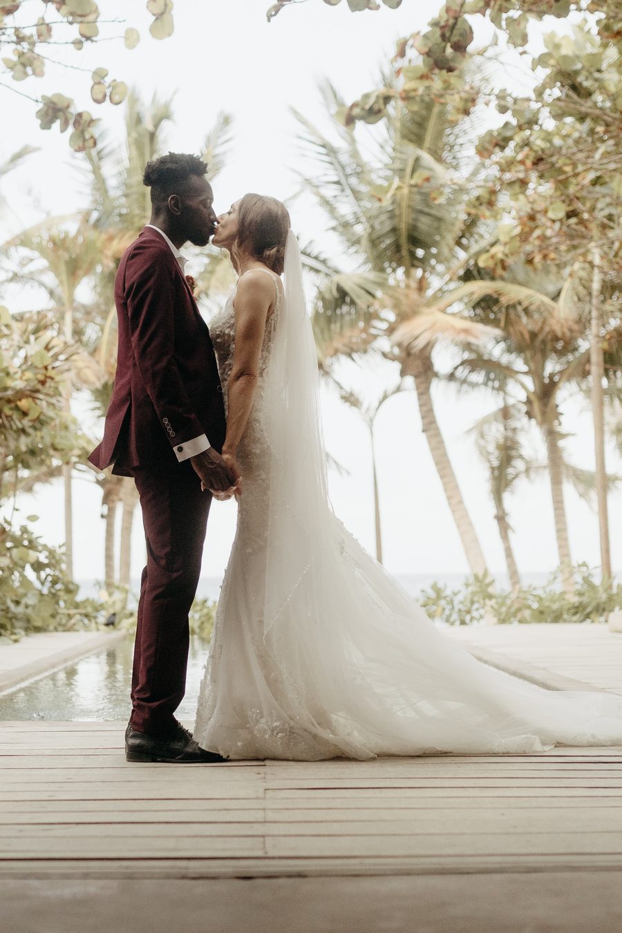 Newlyweds under the palms in Tulum